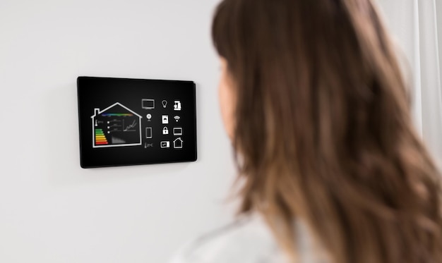 Photo woman looking at tablet computer at smart home