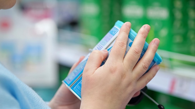 Woman looks for baby food and carefully reads description