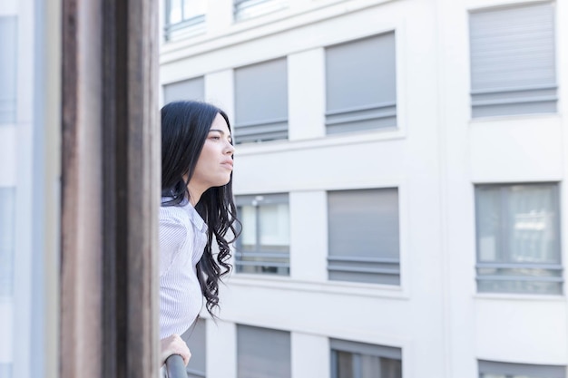 Woman looks out a hotel window