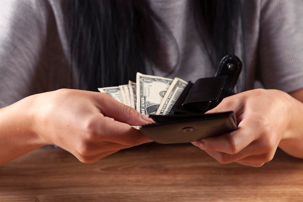 woman looks in the wallet Cash close up