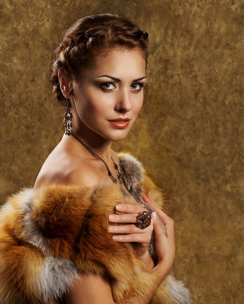 Woman in luxury golden fox fur coat