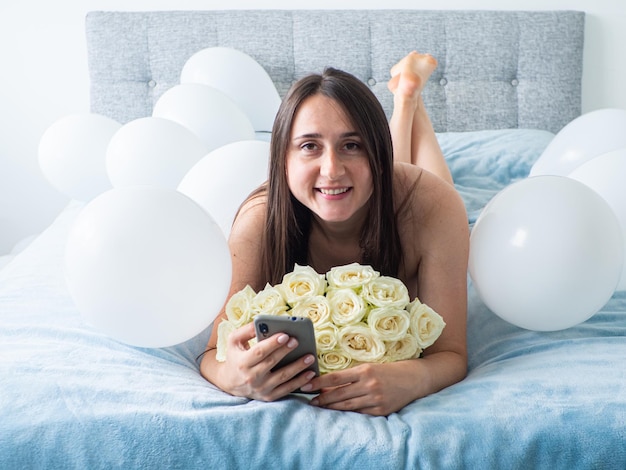 Woman lying on bed with decorations with balloons for Birthday party