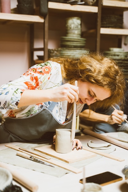 Woman making ceramic pottery.