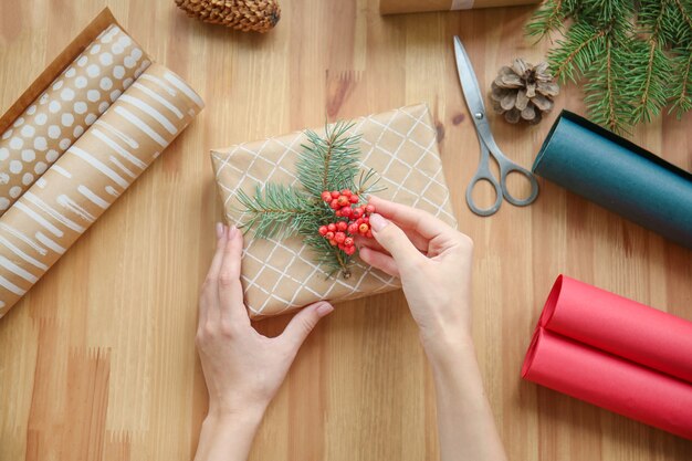 Woman making Christmas gift at table