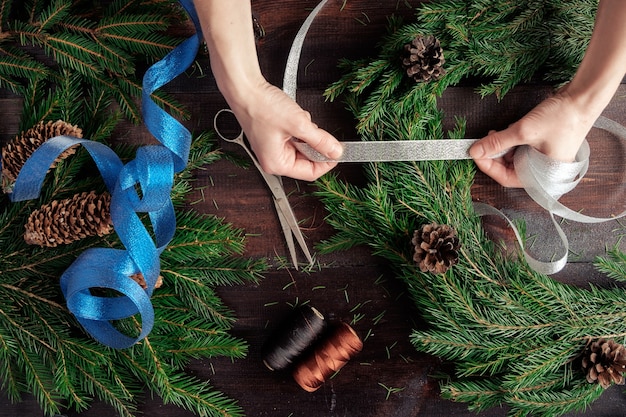 Woman making christmas wreath hands