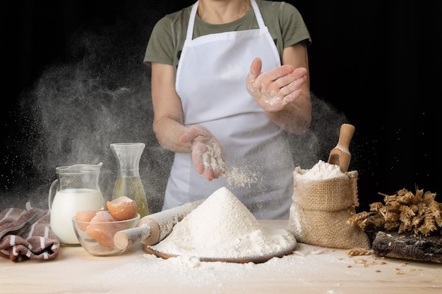 Woman making Easter baking at home bakery. woman preparing bread dough on a wooden table in a bakery nearby