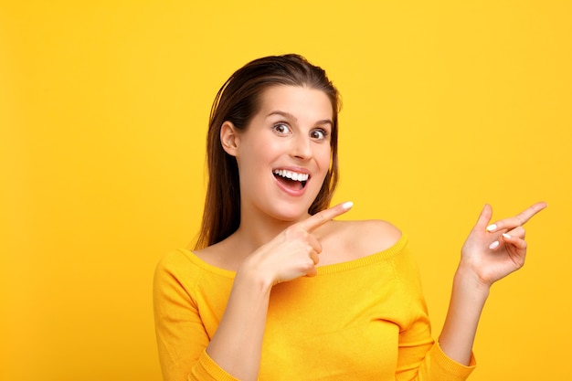 woman making faces against yellow