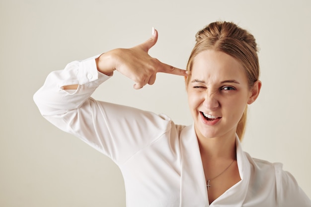 Woman Making Headshot With Finger