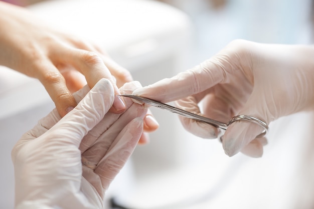 Woman making manicure, Master of nailart in the salon.