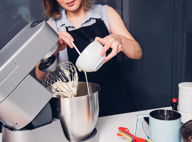 Woman making mixer bakery cake machine