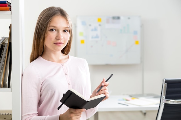 Woman making notes in notepad