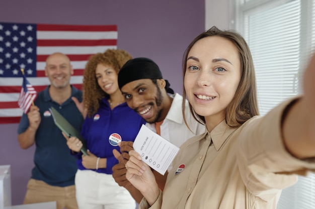 Woman making selfie portrait at election day