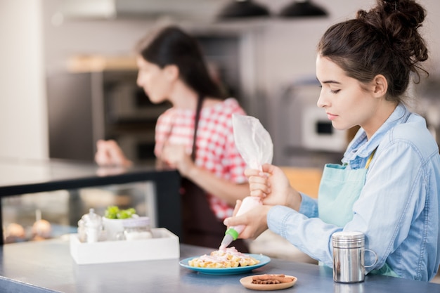 Woman Making Waffles in Cafe