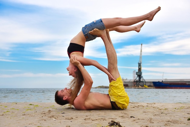 Woman and man doing acrobatic yoga