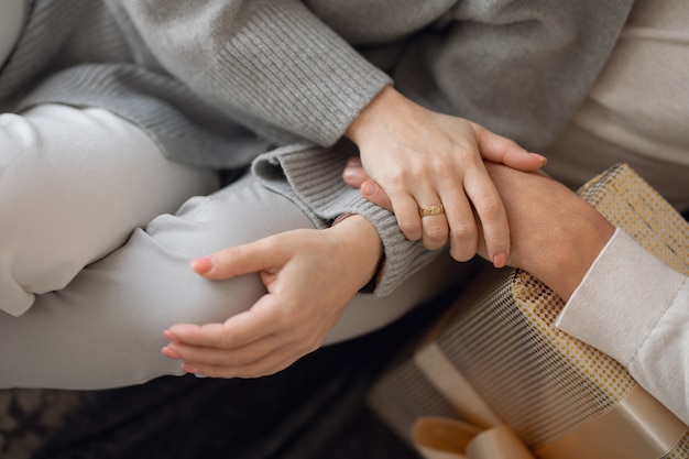 woman and man holding hands closeup