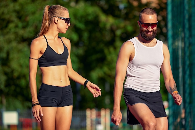 Woman and man jogging in the stadium