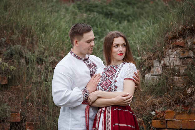 Woman and man wearing traditional clothes in nature