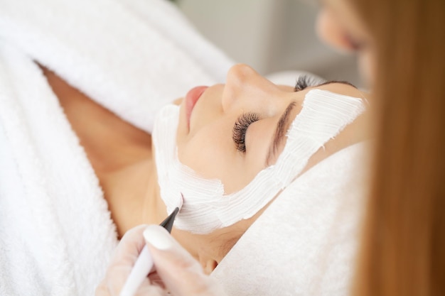 Woman in mask on face in spa beauty salon