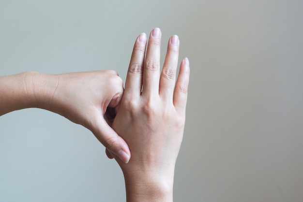 Woman massaging her painful hand and finger