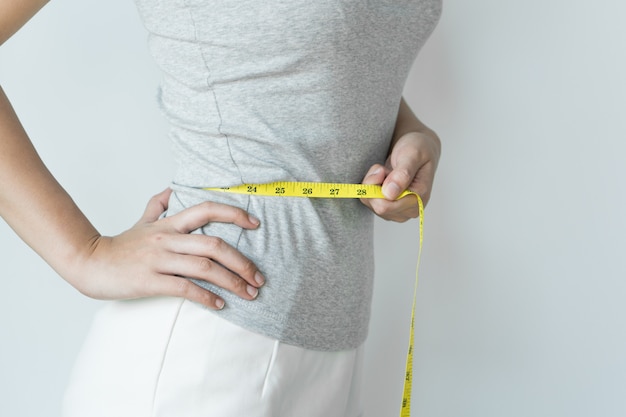 woman measuring her waist.