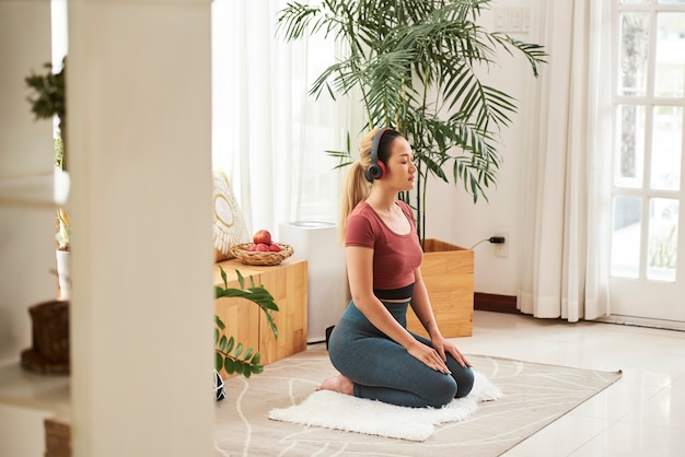 Woman meditating in headphones