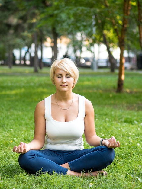 woman meditating in park