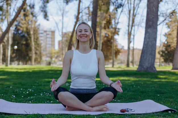 A woman meditating in a park