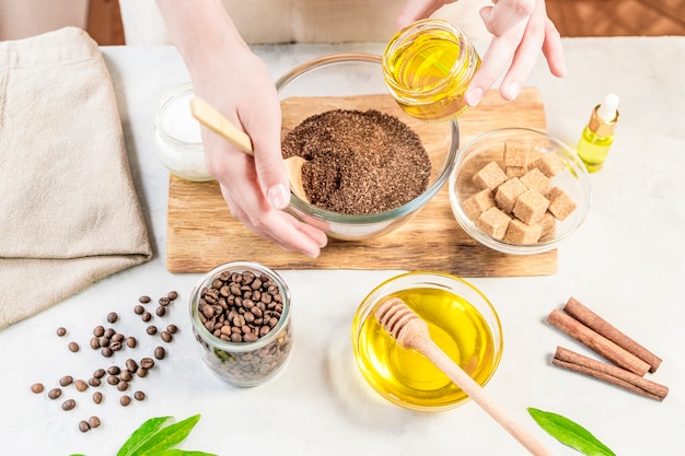 Woman mixing ingredients preparing coffee scrub or mask for skin treatment