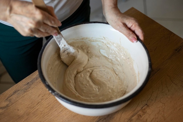 Woman mixing sourdough in a bowl