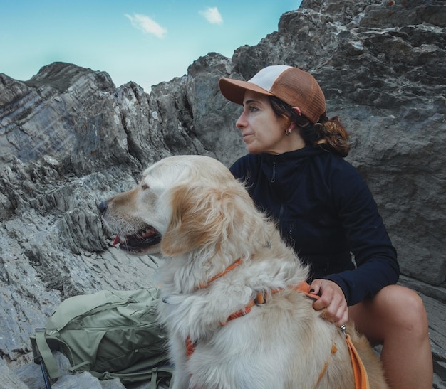 Woman mountaineer high mountain dog