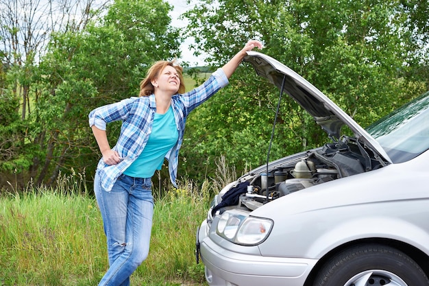 Woman near broken car