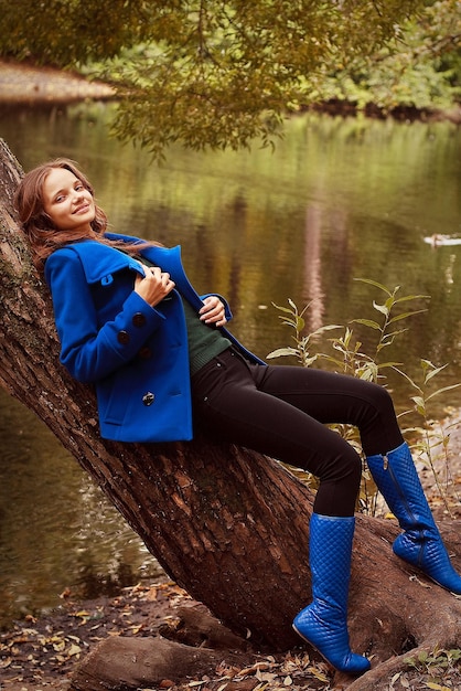 Woman near the river in autumn season