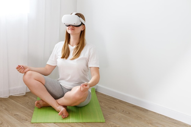 A woman in oculus vr meditates at home