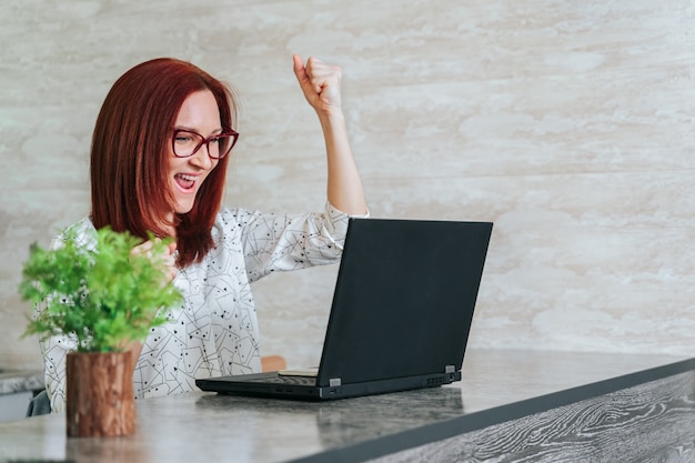 Woman at office desk with laptop feeling great on career horizon