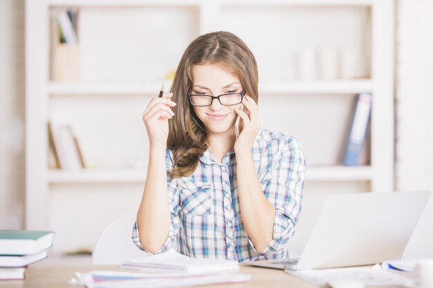 Woman in office talking on phone