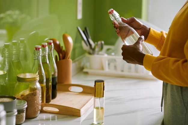 Woman Opening Bottle of Vinegar