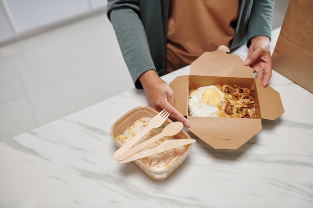 Woman Opening Box of Food