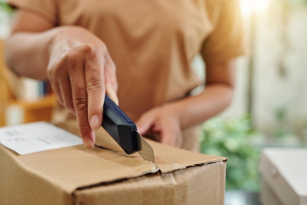 Woman Opening Cardboard Box