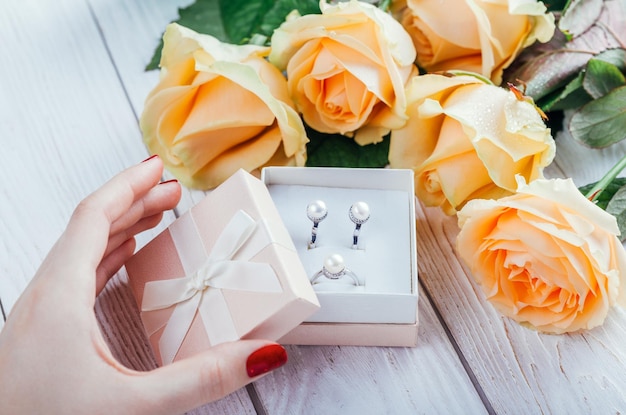 Woman opens a gift box with jewellery