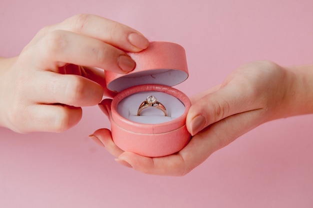 Woman opens a gift box with jewellery