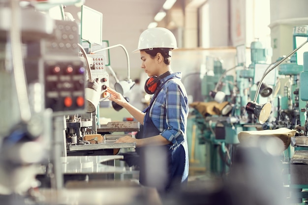 Woman operating manufacturing machine