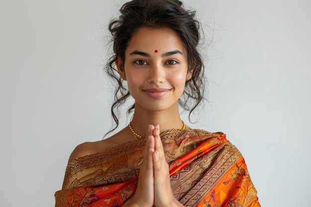 a woman in an orange sari with a gold necklace