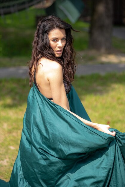 Woman outdoor wearing lingerie on summer field