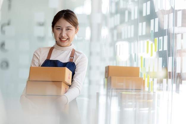 Woman owner of a startup company selling products online on an online store platform sending goods through a courier company Business planning Online selling and online shopping concepts