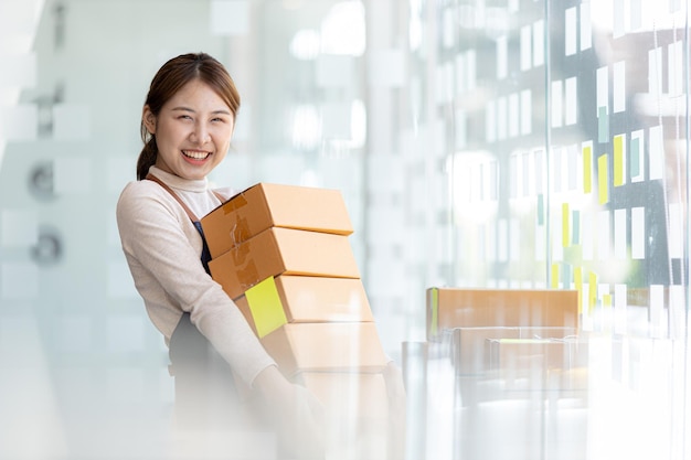 Woman owner of a startup company selling products online on an online store platform sending goods through a courier company Business planning Online selling and online shopping concepts