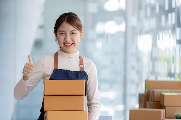 Woman owner of a startup company selling products online on an online store platform sending goods through a courier company Business planning Online selling and online shopping concepts