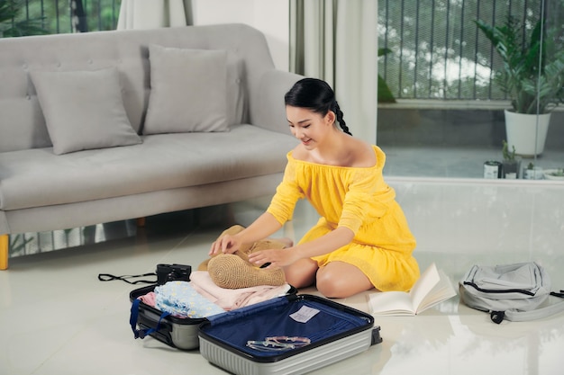 Woman packing suitcases at home