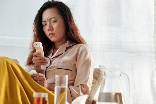 Woman in Pajamas checking Body Temperature