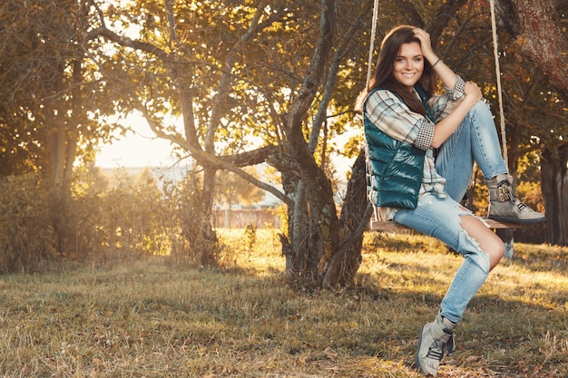 Woman in the park at sunny autumn day