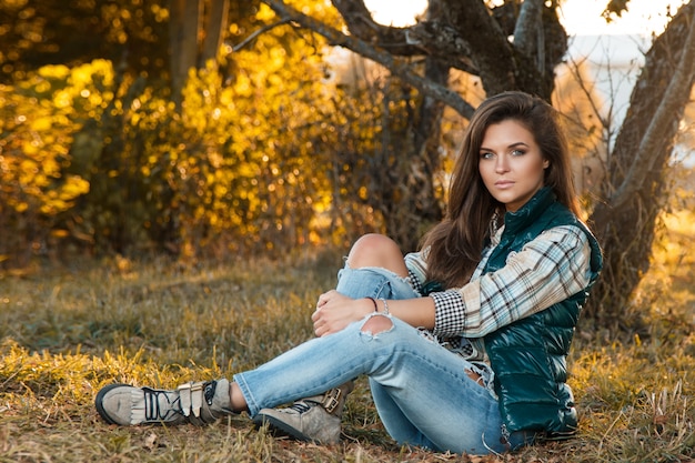 Woman in the park at sunny autumn day